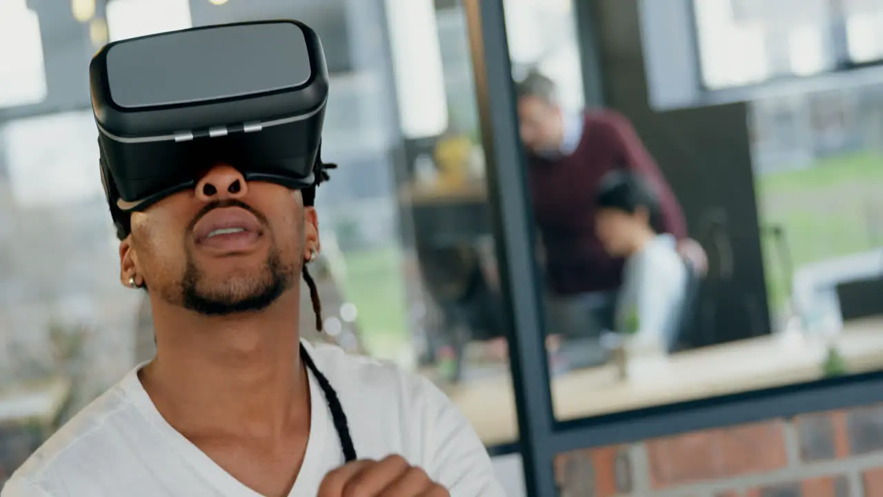 Male executive using virtual reality headset in office 4k