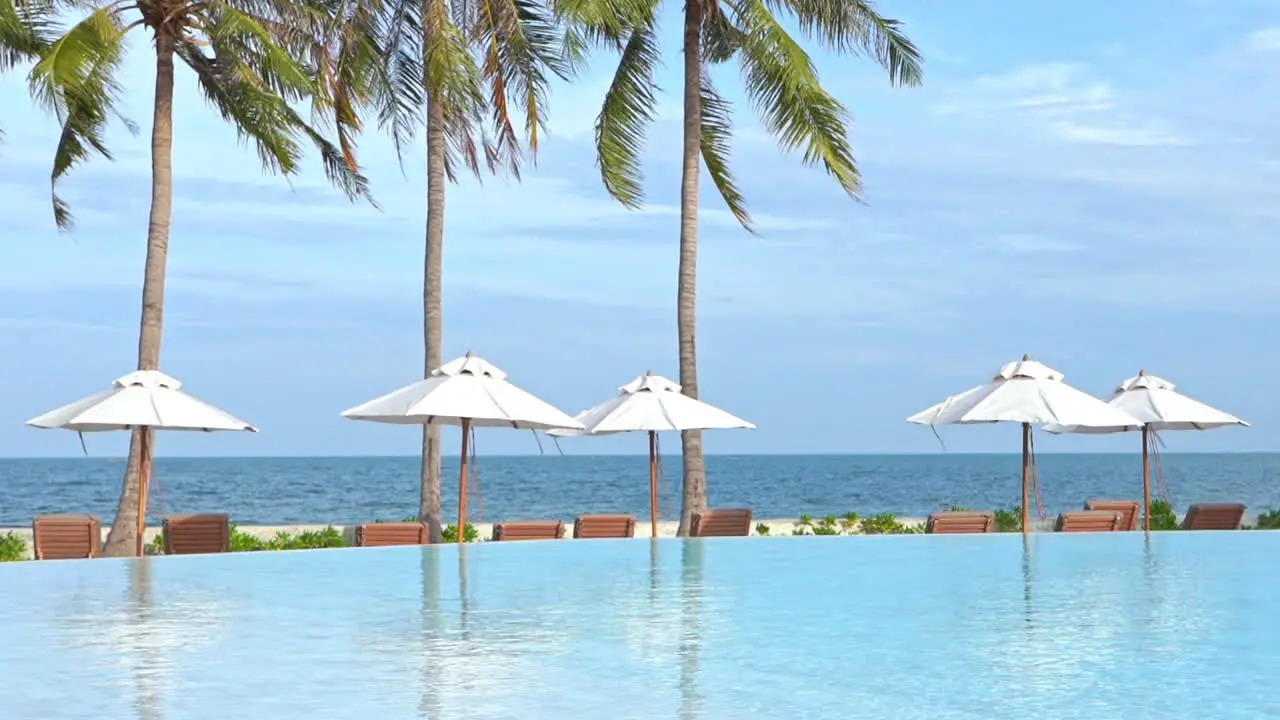 Sea view resort with infinity pool and white sun umbrellas