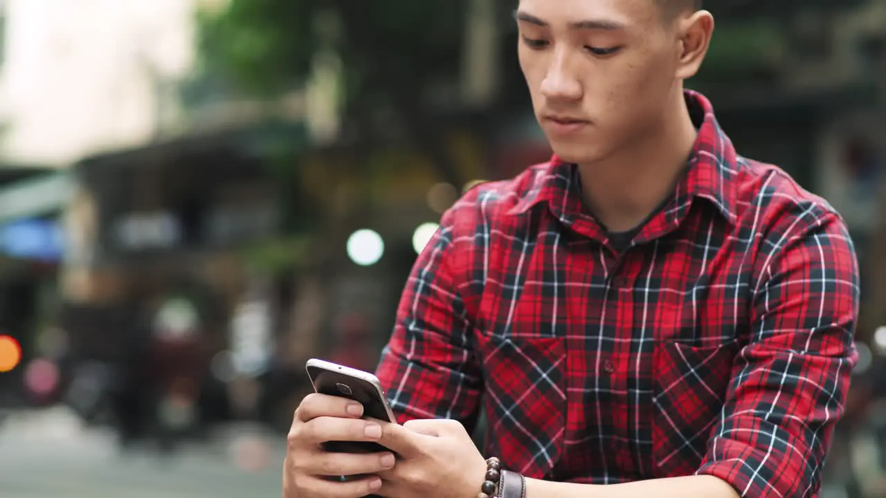 Handheld view of Vietnamese man with cell phone