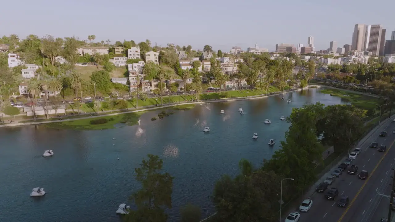 Drone Flying Over Echo Park Lake on Sunny Afternoon Approaching City Skyline of Downtown Los Angeles