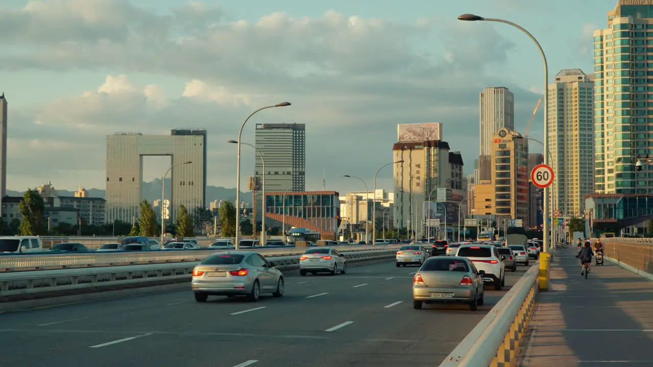 Car Traffic on Hangang Bridge in Seoul at Sunset with Yongsan District Urban Skyline roadside real time