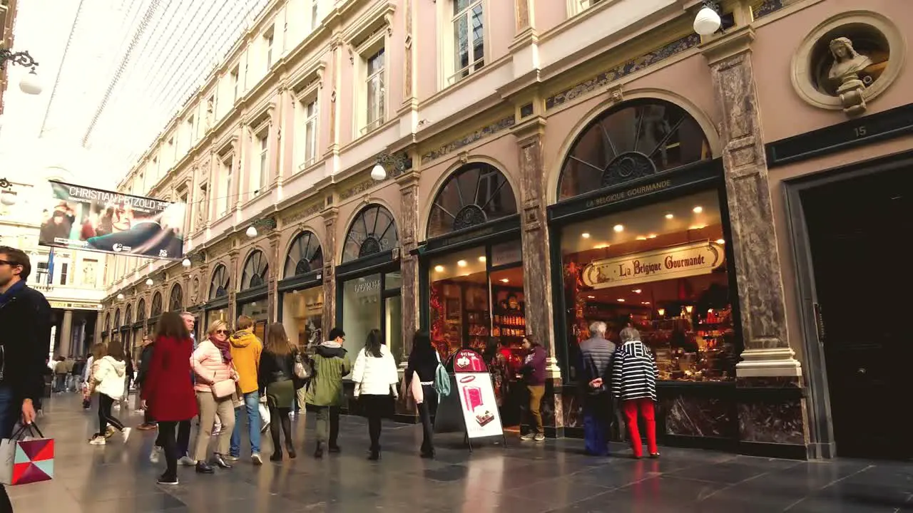 People walk and shop at Galerie de la Reine Brussels Belgium