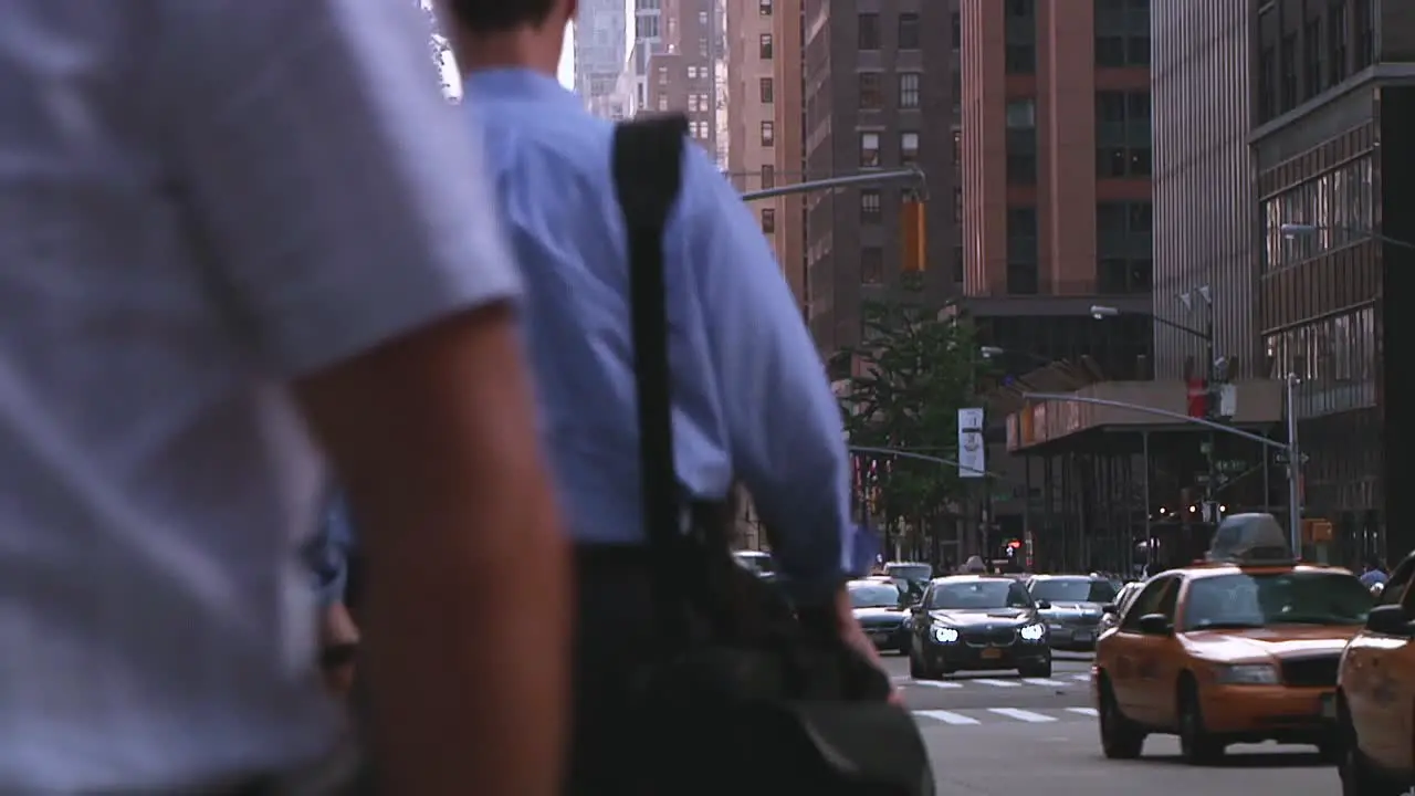 New York City street scene with busy pedestrians and cars passing