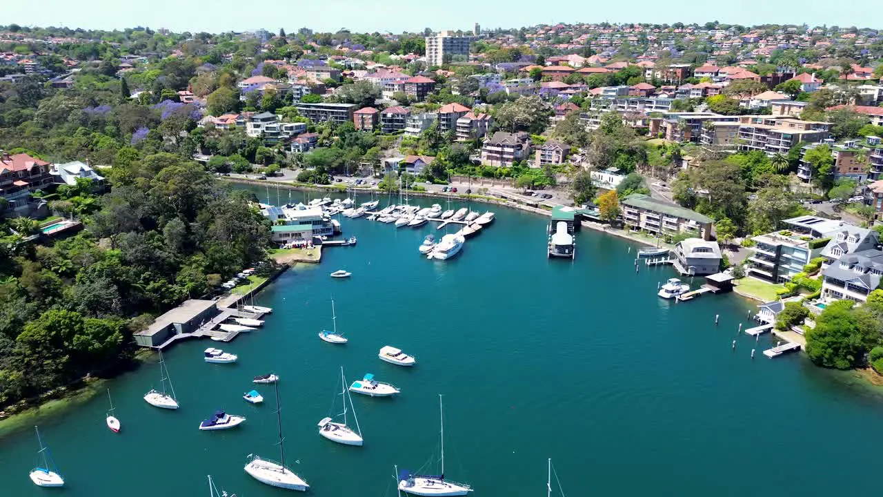 Drone aerial landscape view of boats yachts harbour ferry service housing residential units Mosman Bay Cremorne Point North Sydney Neutral Bay boating sailing travel tourism NSW Australia 4K