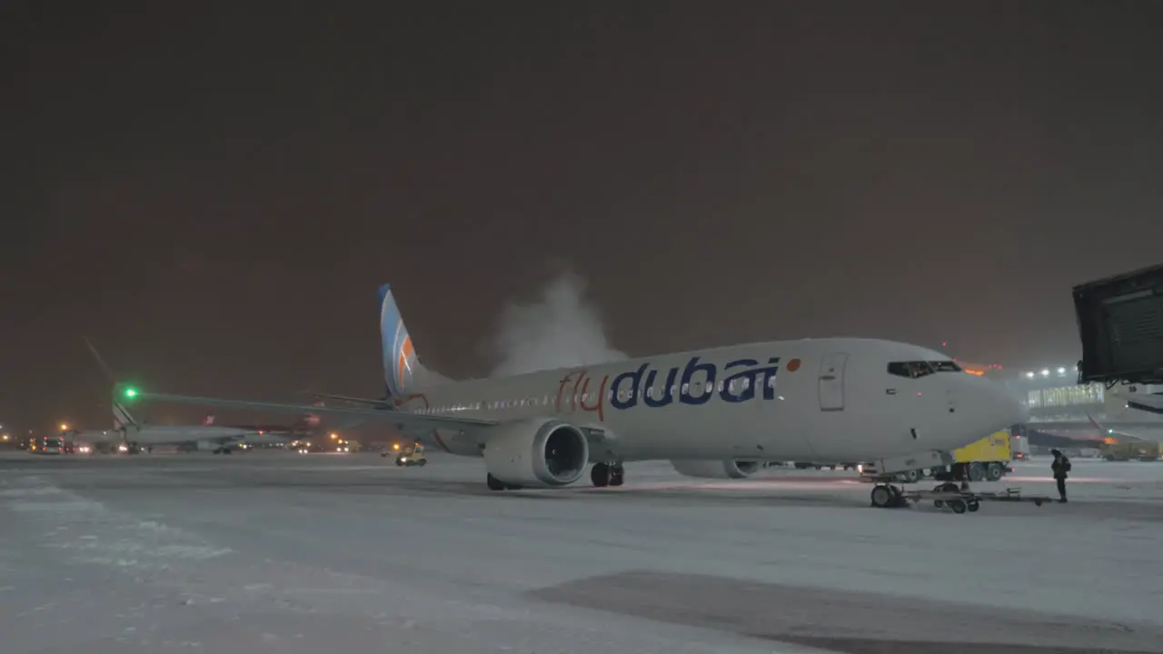 Flydubai Boeing 737 MAX-8 in the airport at winter night