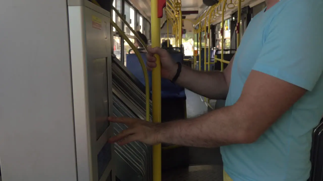 Man using bus ticket machine