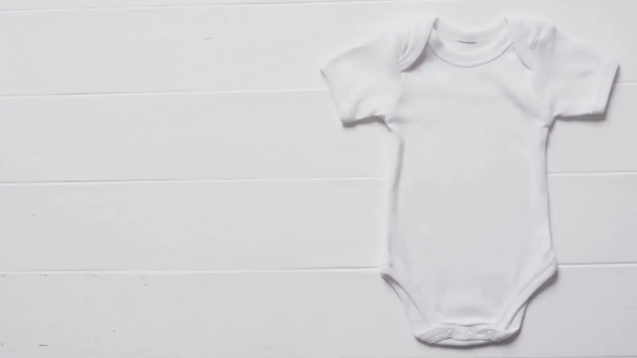 Video of white baby grow with copy space on white background