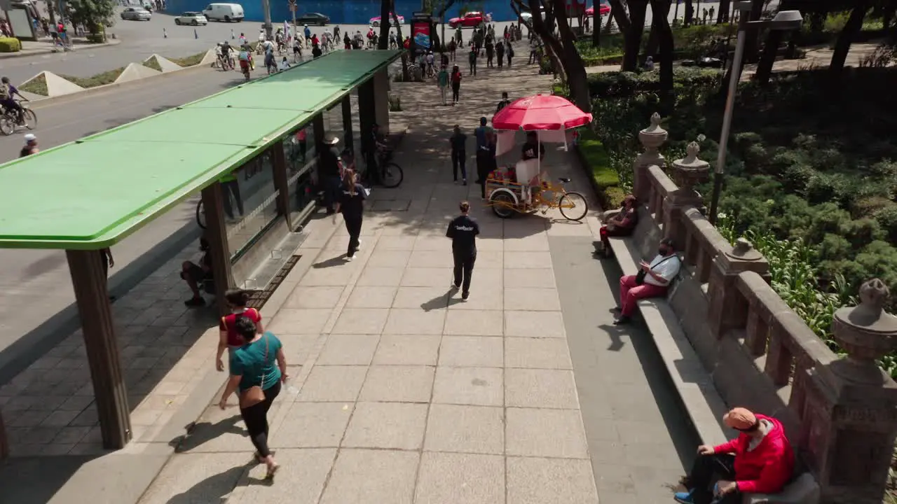 Aerial above people walking on sidewalk at public street in reforma mexico