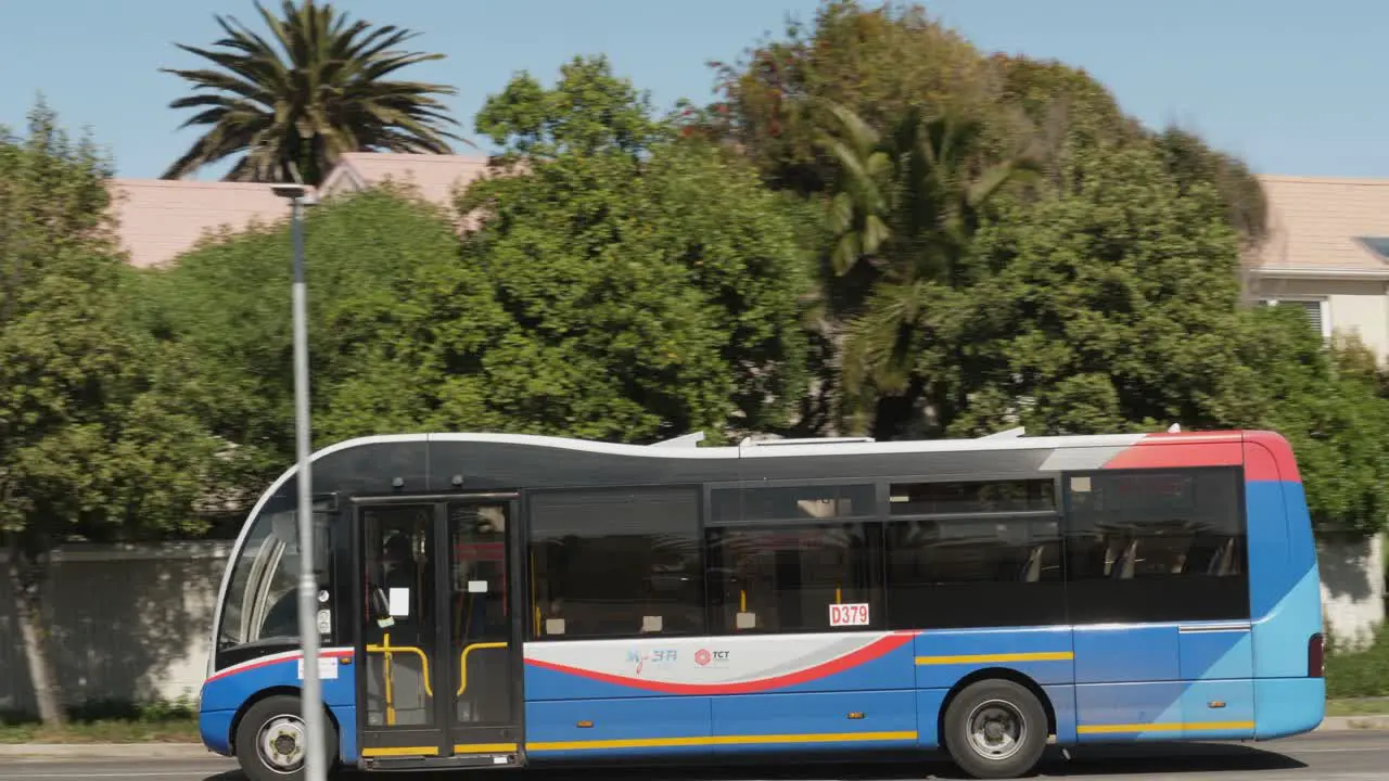 Pan with city transit bus as it drives across bridge in Cape town RSA