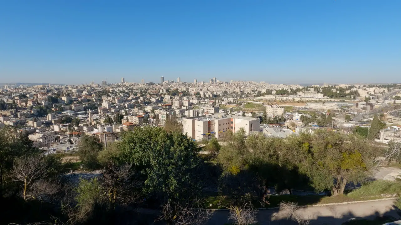 High angle pan across Jerusalem city sprawling off into the distance