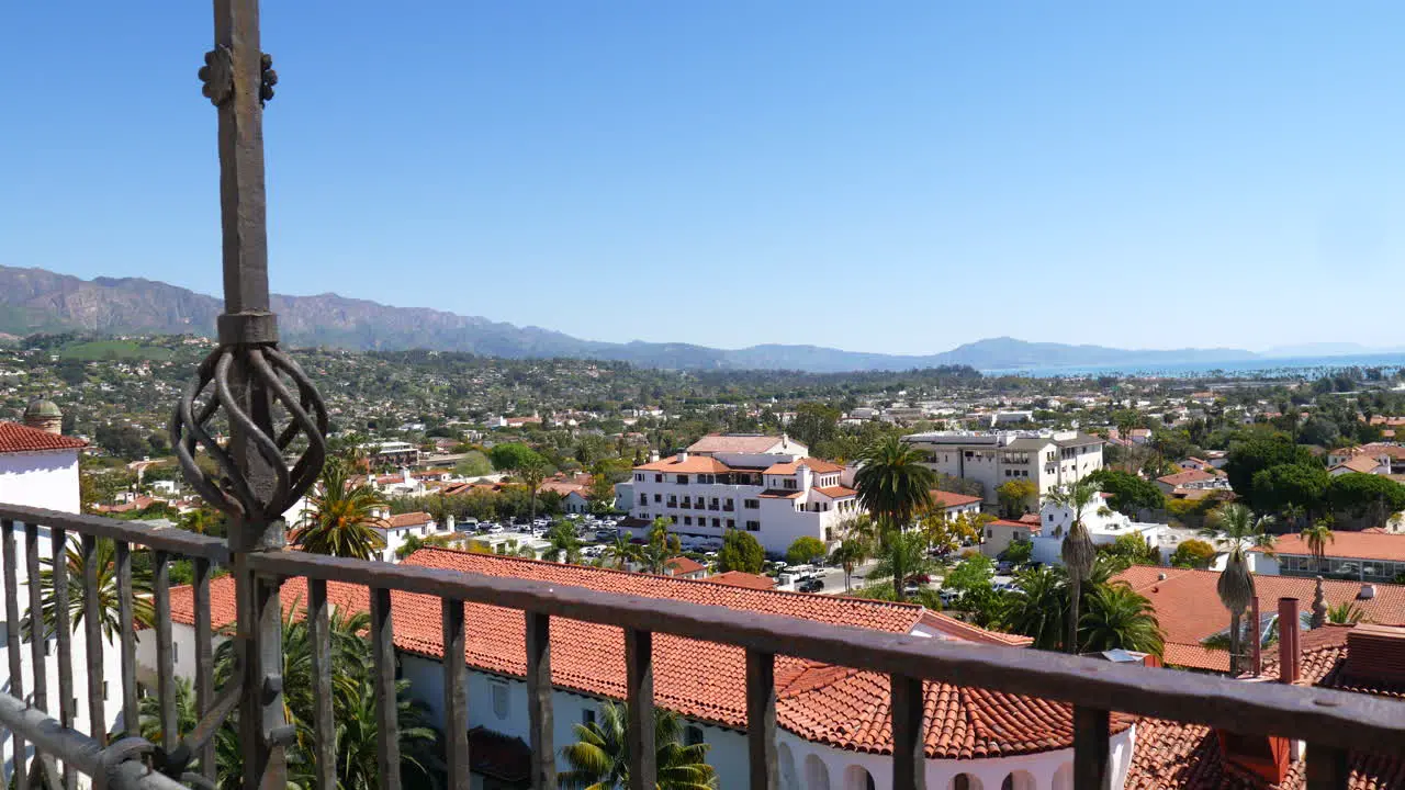 Looking down on the view of Spanish roof architecture and city buildings leading out to the ocean in downtown Santa Barbara California