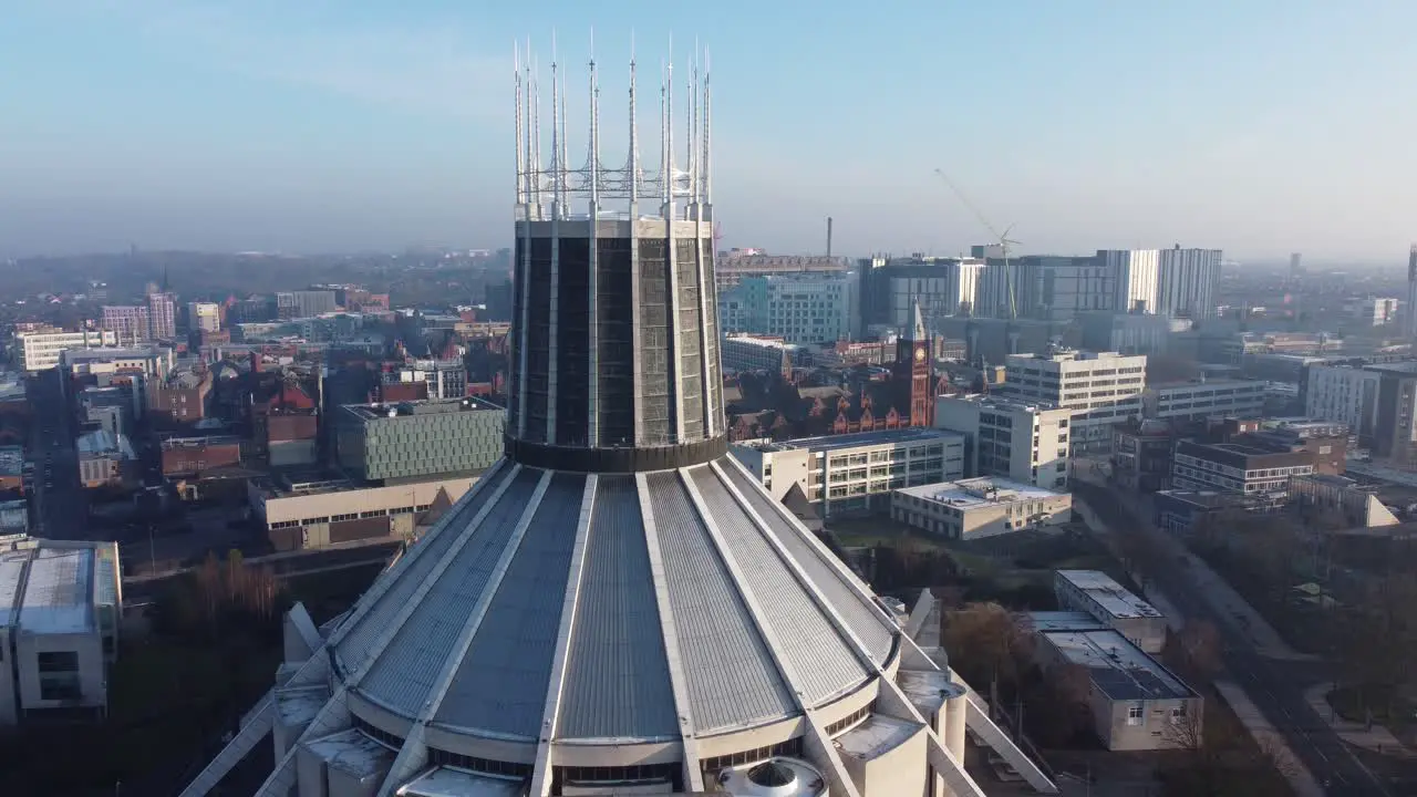 Liverpool Metropolitan cathedral contemporary city landmark rooftop spires aerial rising pull back