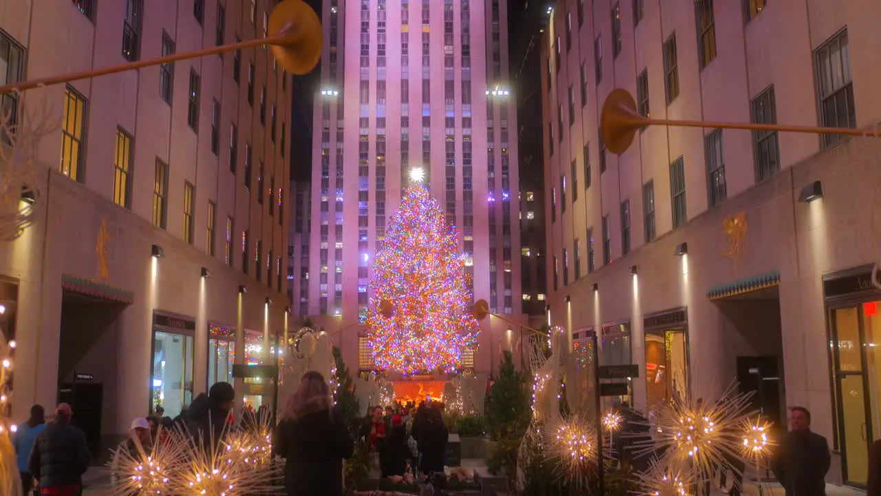 Iconic Christmas Tree At The Rockefeller Center In New York City With Busy People At Night