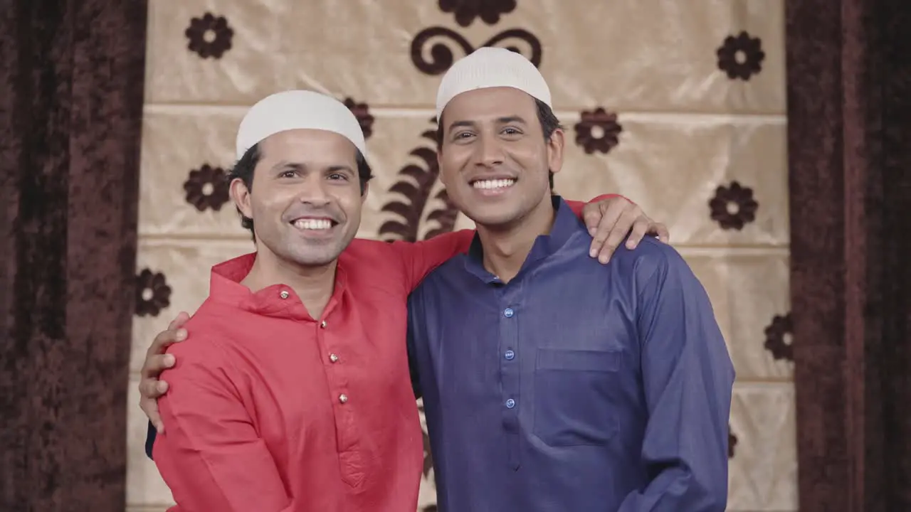 Two happy muslim friends hugging and enjoying