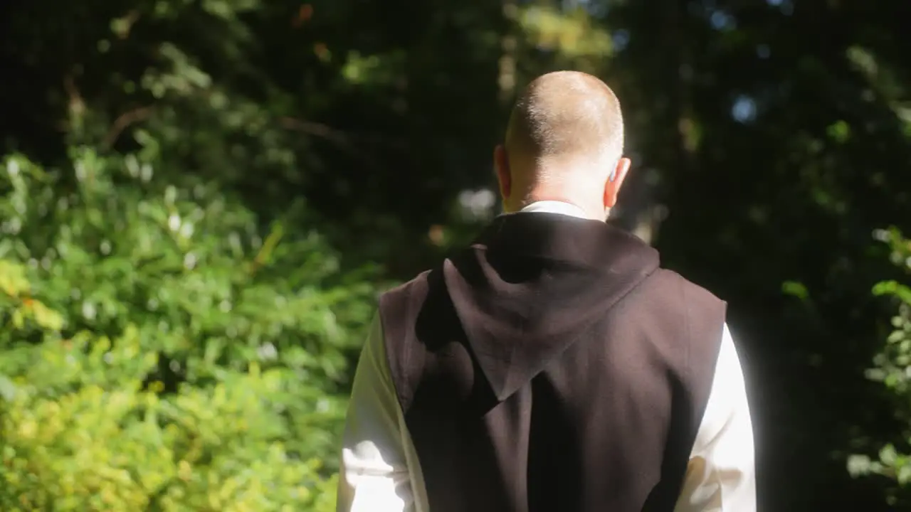 A monk walking in a forest