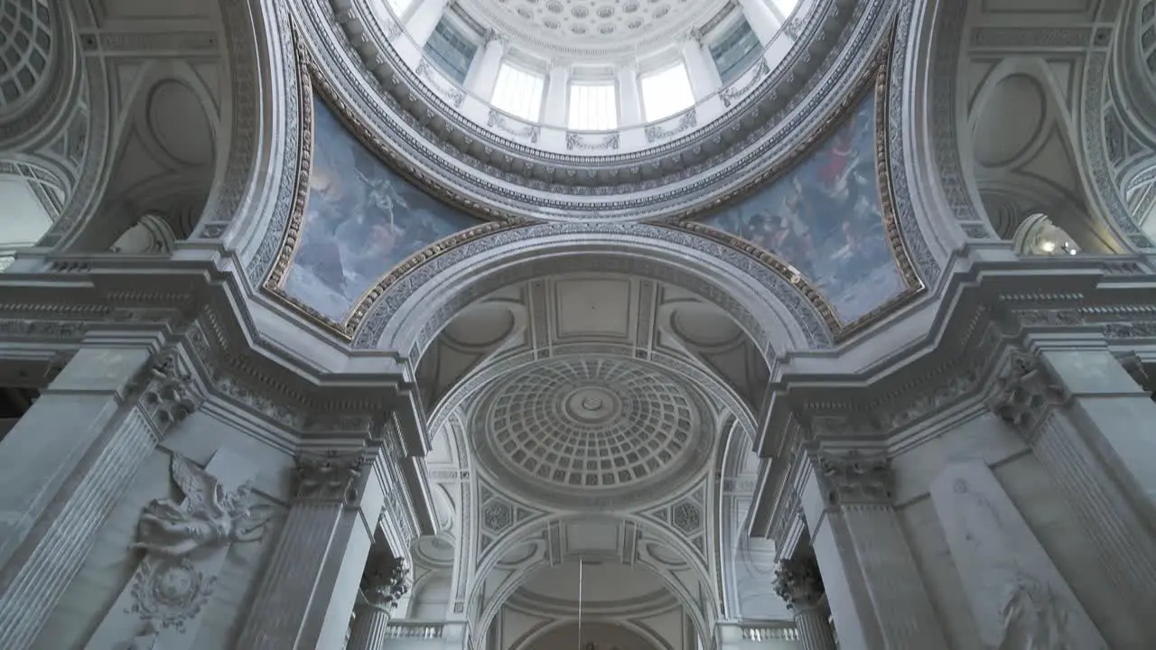 Pan down from the domed roof to the Foucault pendulum which is a device used to demonstrate the Earth's rotation