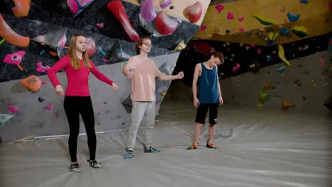 Friends warming up in a climbing gym