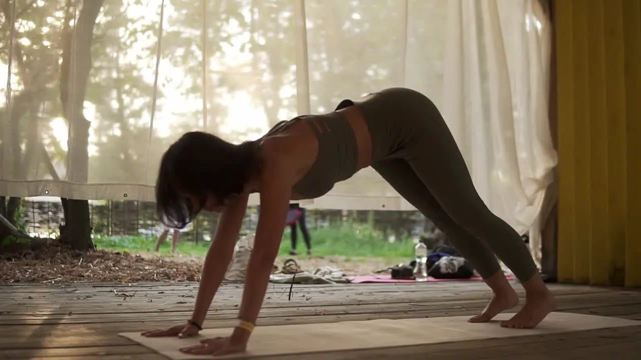 Fit Woman Is Doing Yoga In Wooden Hut Filled With Light The Girl Performs Yoga Stands And Elements