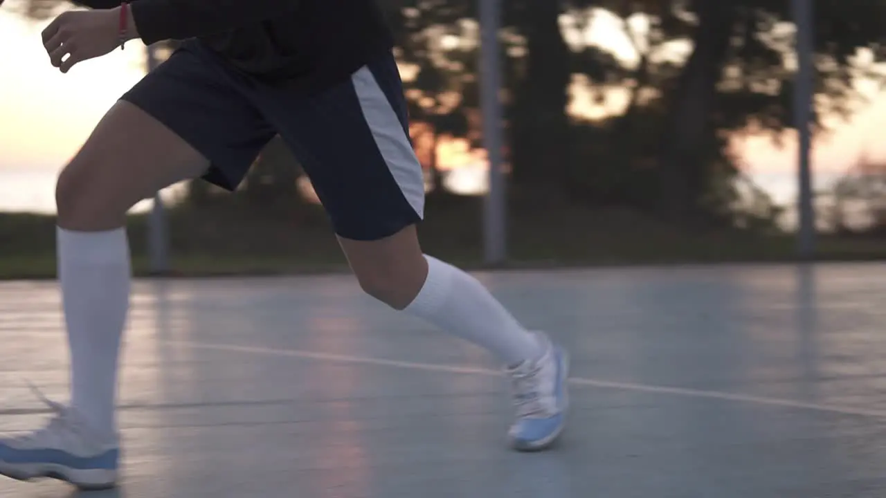 Close Up Footage Of A Young Girl Basketball Player Training And Exercising Outdoors On The Local Court