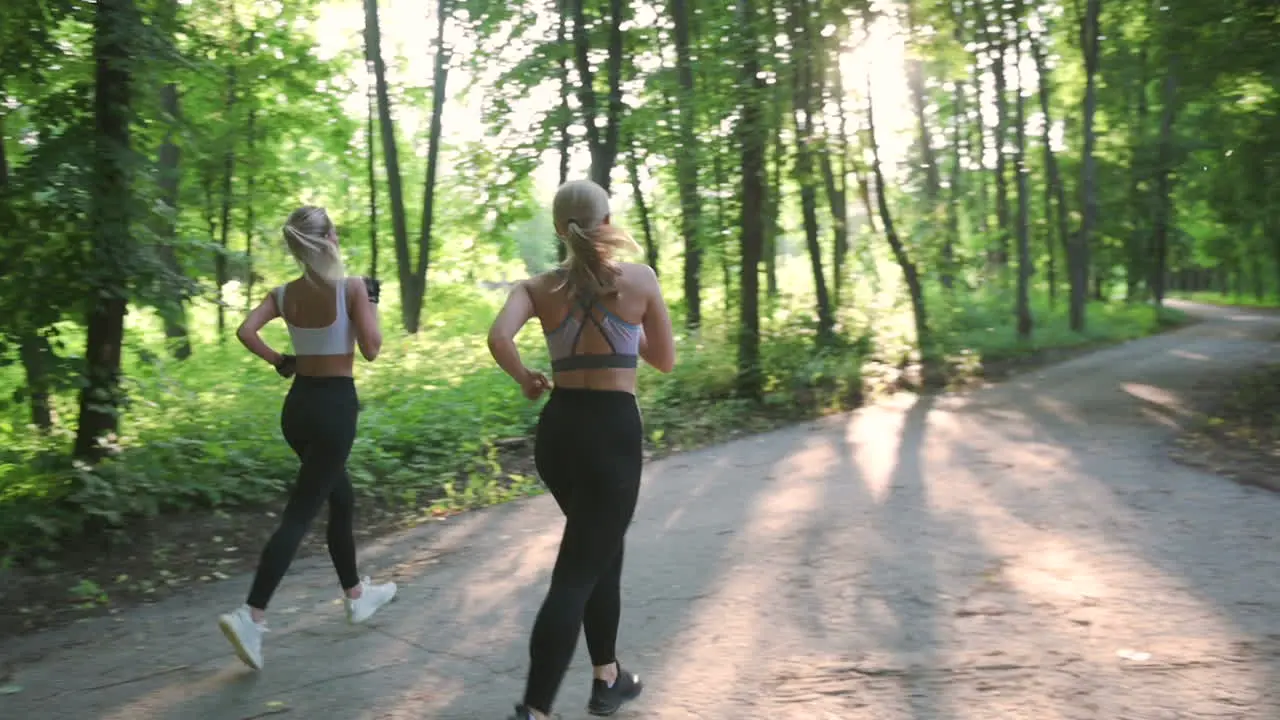 Pretty Blonde Girls Running In The Park In A Sunny Day