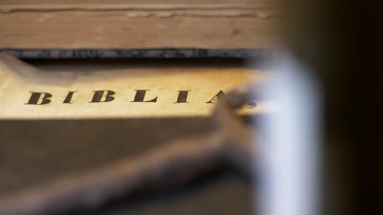 Ancient holy bible book title is revealed in slow slider motion shot