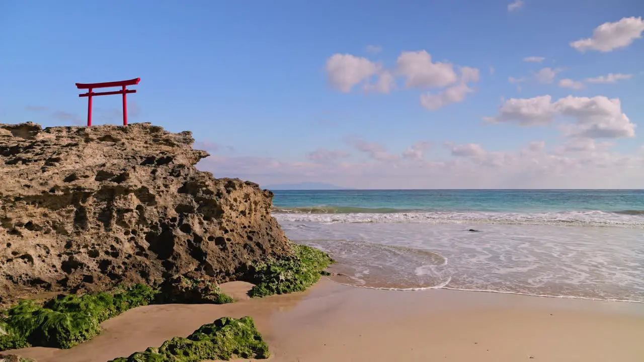 Beautiful Japanese scenery at beach with traditional gate on top of rock