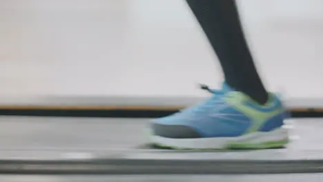 Closeup running legs on treadmill in fitness gym