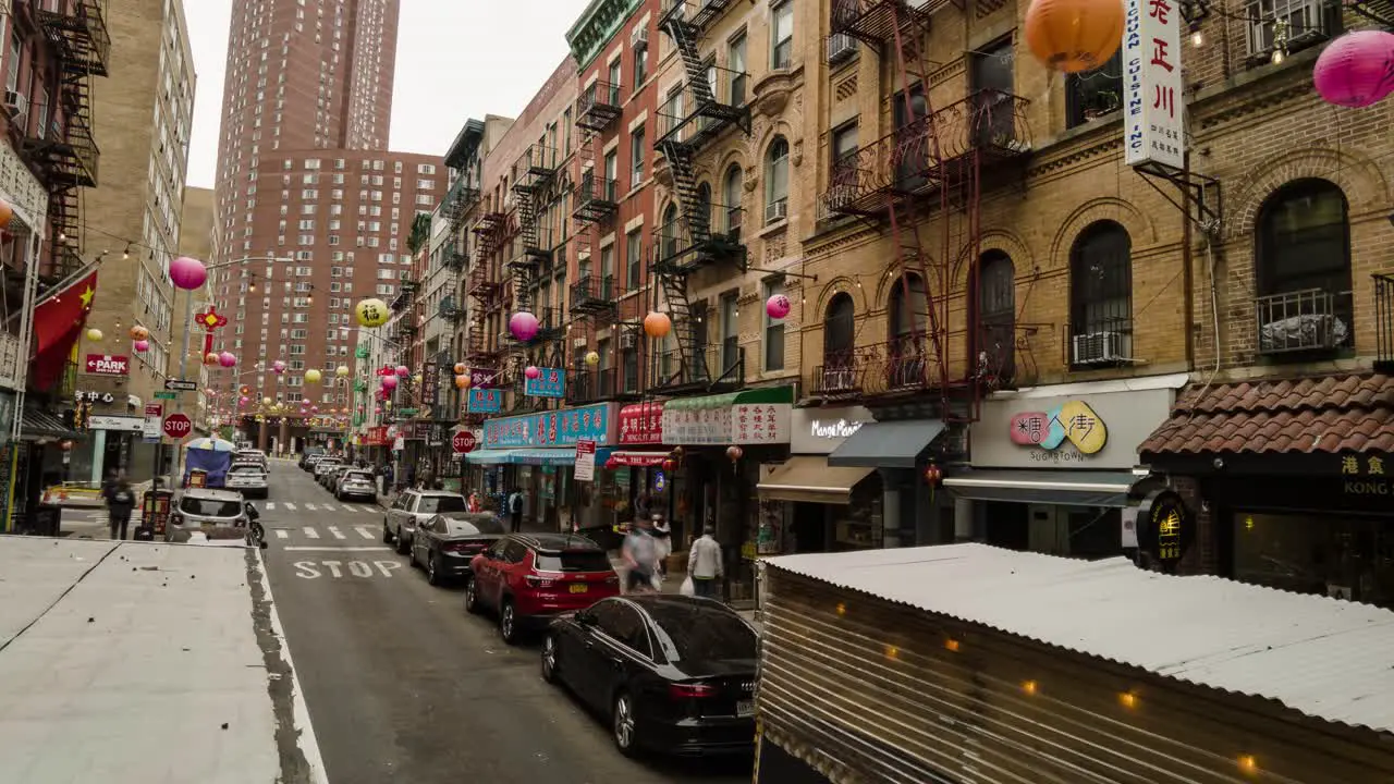 timelapse and motionlapse of Chinatown by day with Chinese decoration and stores while people and vehicles pass by