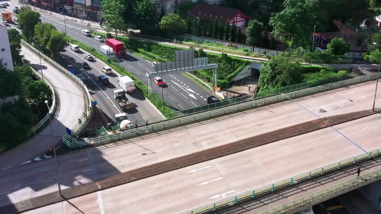 Aerial view Kowloon city traffic driving Hong Kong highway cityscape low angle dolly right