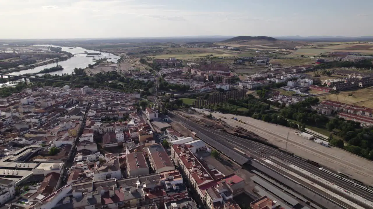 Aerial view orbiting the city of Merida Spain alongside Guadiana river and skyline of the Badajoz province