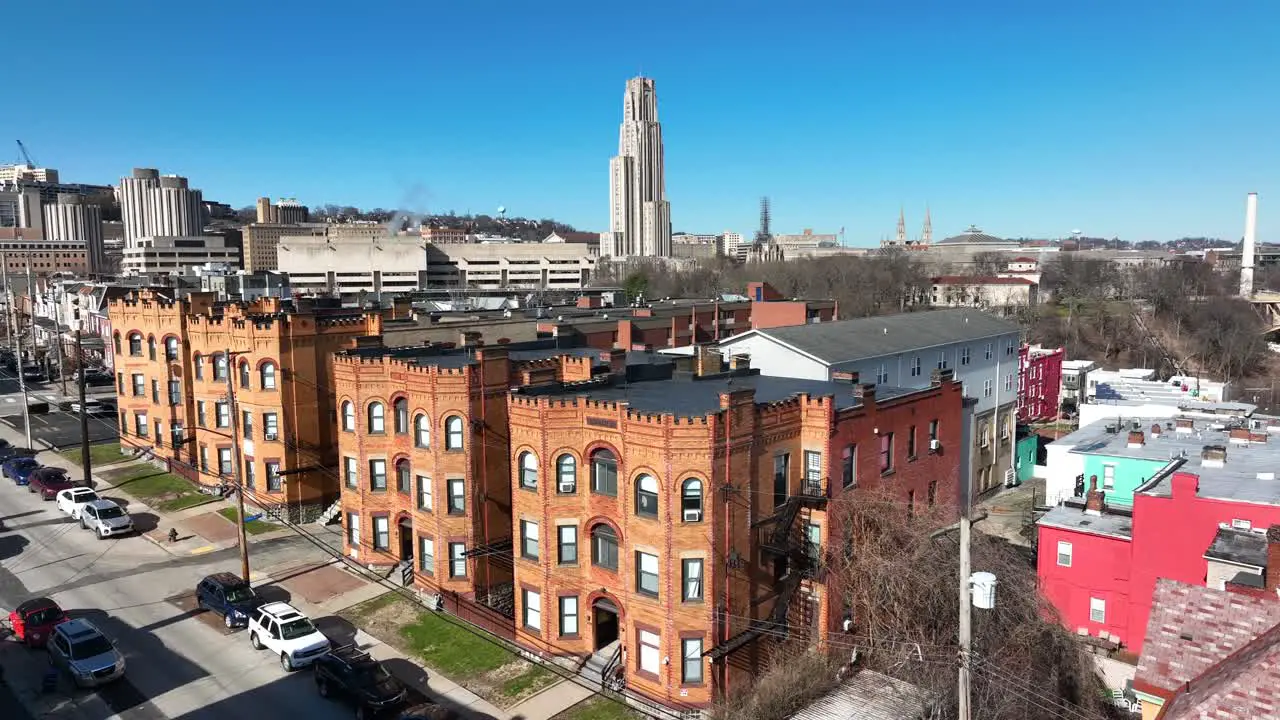 Aerial shot of historic houses in Pittsburgh Pennsylvania with Pitt Cathedral of Learning in background