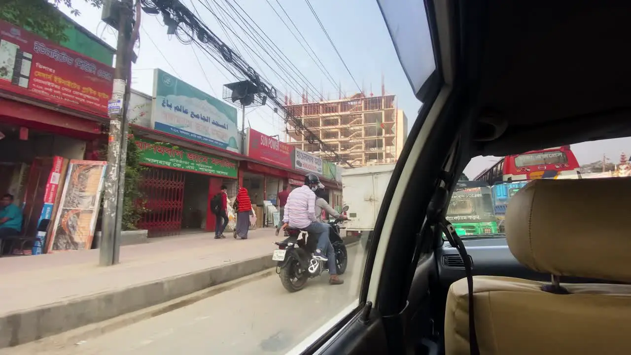 First person view of the city streets from the inside of a car traveling in urban area