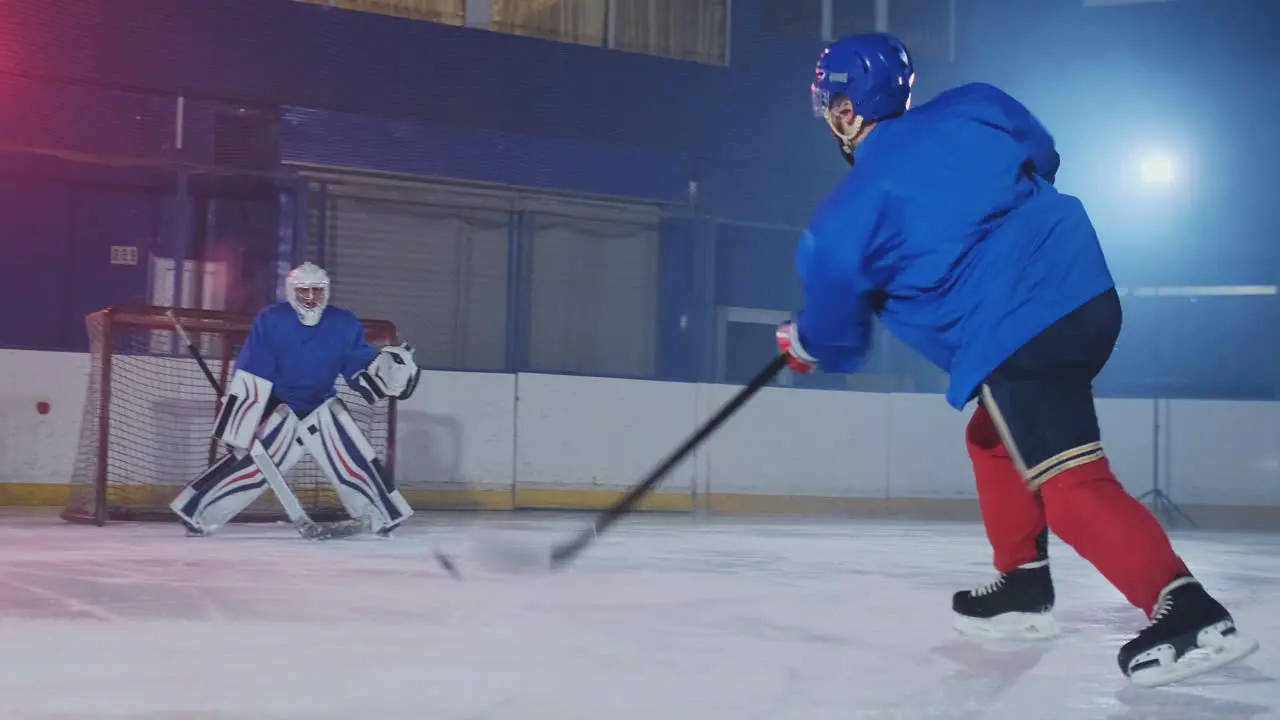 Professional hockey player attacks the gate and strikes but the goalkeeper beats the puck A goal in hockey Puck scored