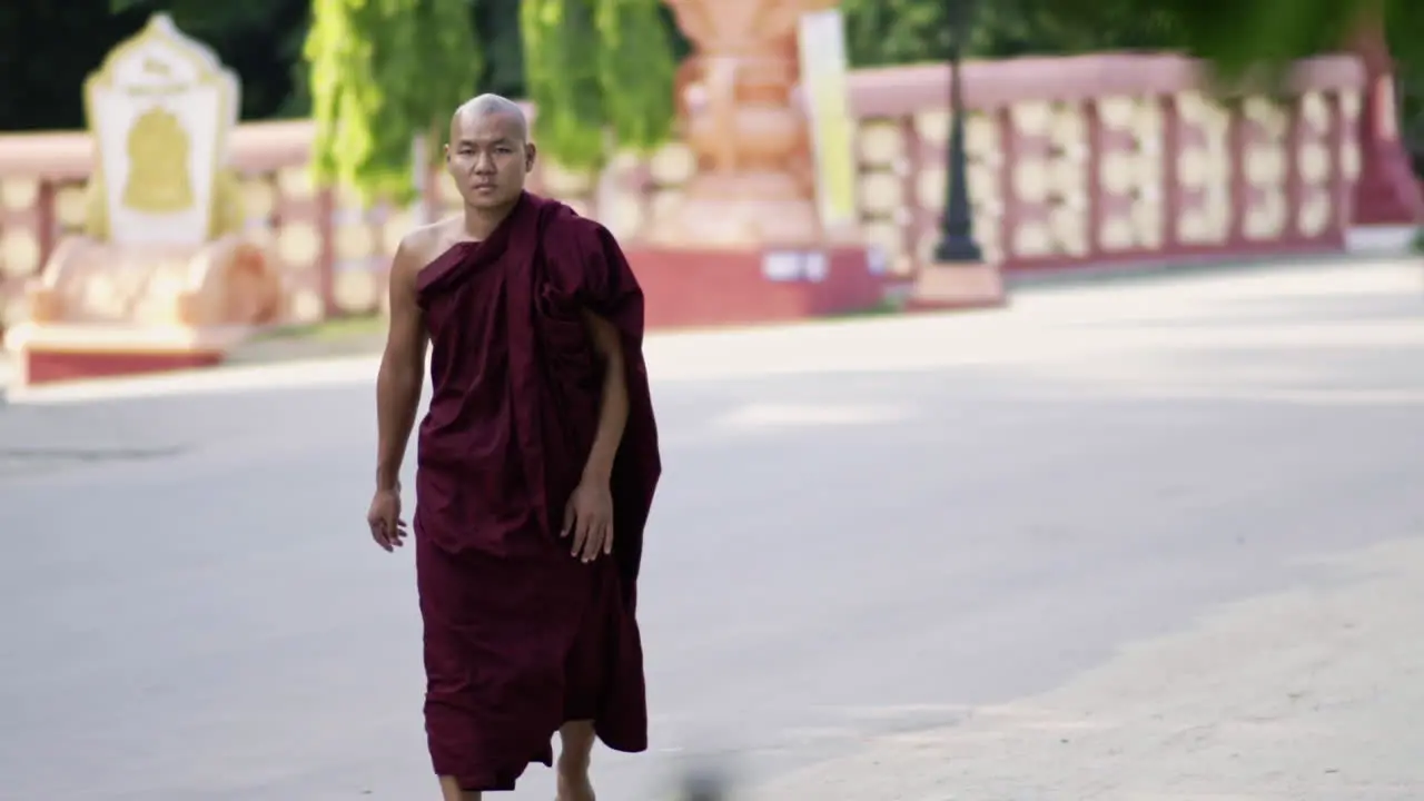 traditional burmese monk walking on the street in mandalay