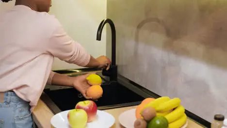 Woman cleaning fruits