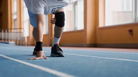 Young man ready to run indoors