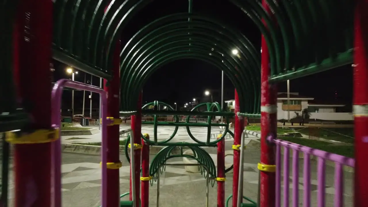 Reverse shot of a kids playground at night