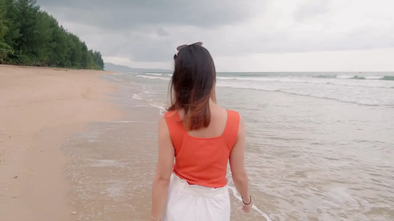 A young asian woman walk on the beach and relax while on holiday vacation-1