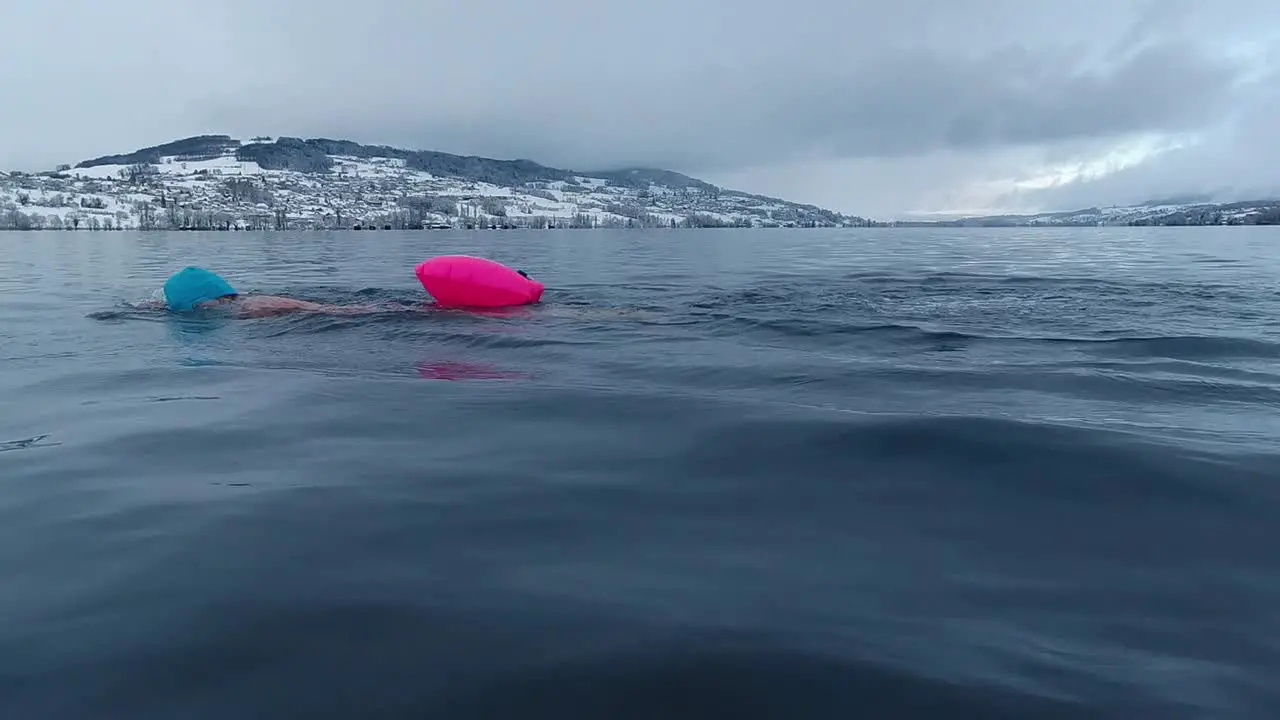 Woman swimming in a lake in Switzerland in winter