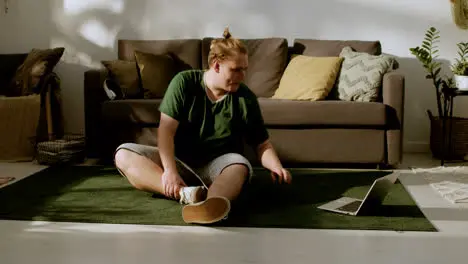 Young guy stretching at home