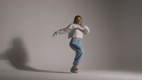 Full Length Studio Shot Of Young Woman Having Fun Dancing Against Grey Background 1