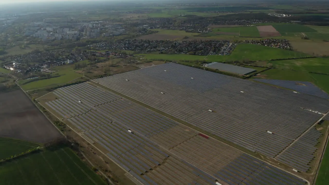 High angle view of large solar park on field on city outskirts Green energy ecology and carbon footprint reduction concept