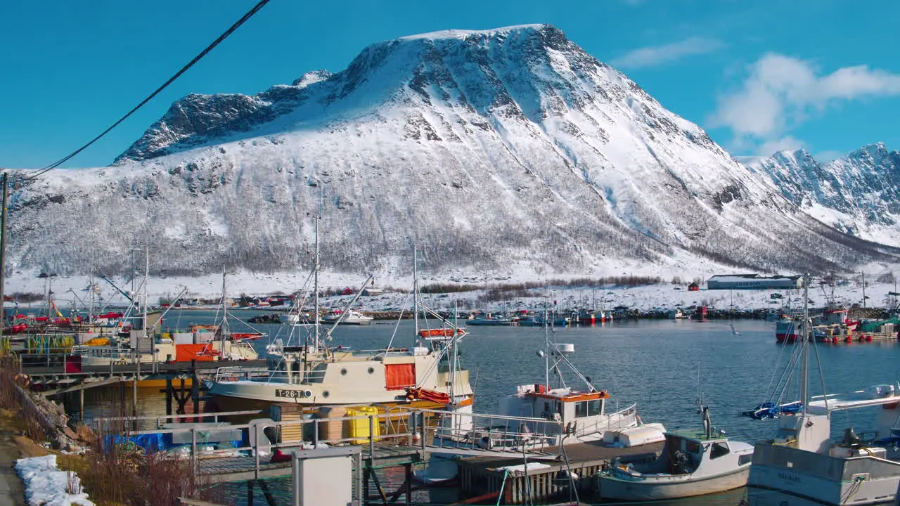 Stunning cinematic tracking shot of fishing boats in Tromvik harbour Norway