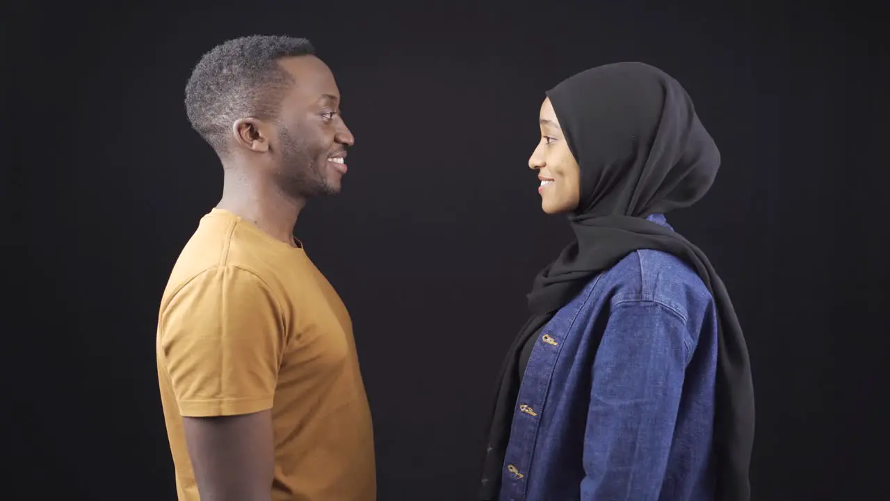 Affectionate african muslim couple loving looking at camera and smiling