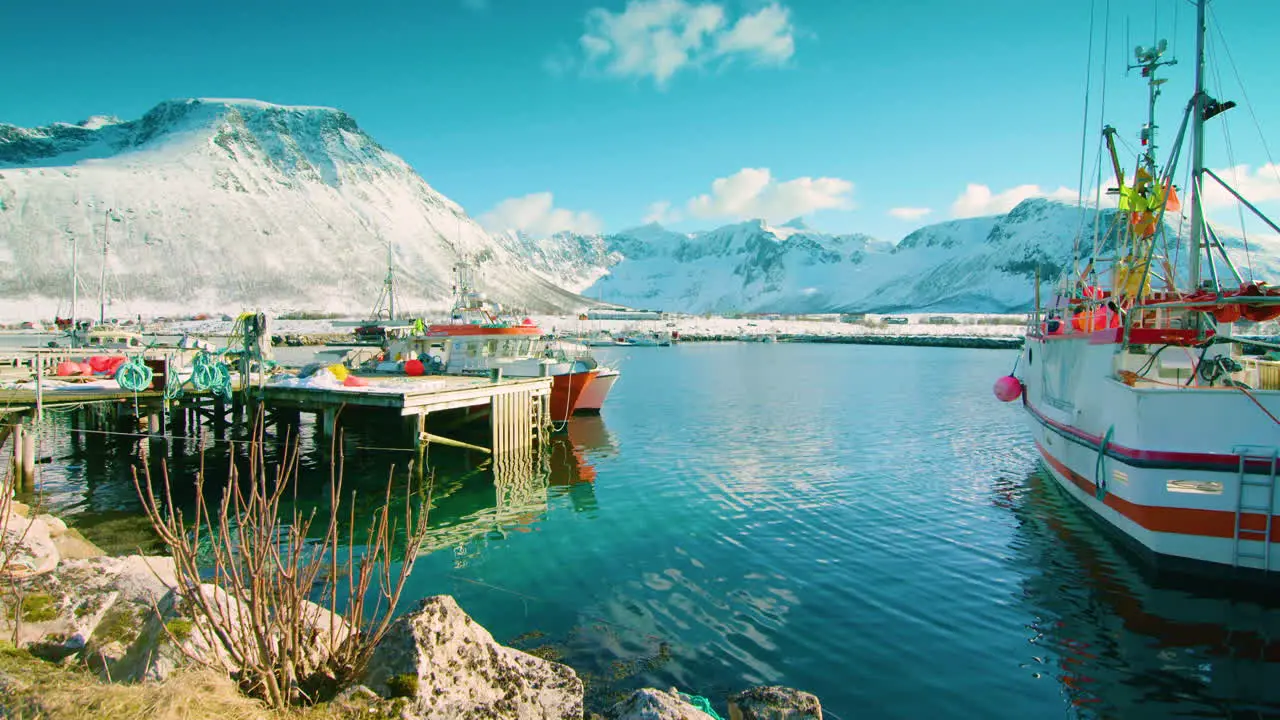 Stunning cinematic tilt up shot of fishing boats in Tromvik Norway