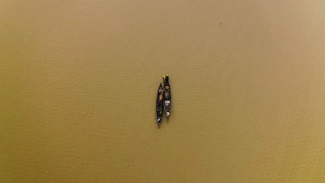 Fishermen cruising on a lake in their canoes