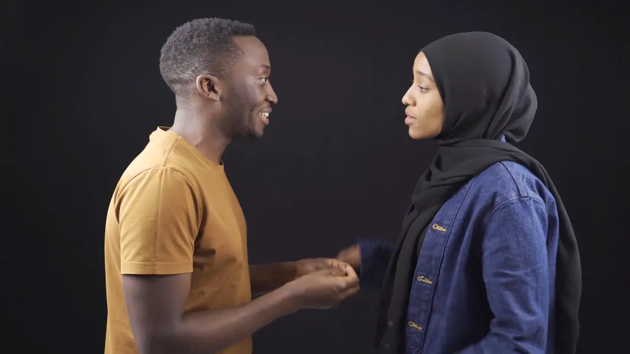 African muslim couple arguing fighting and judging each other on black background