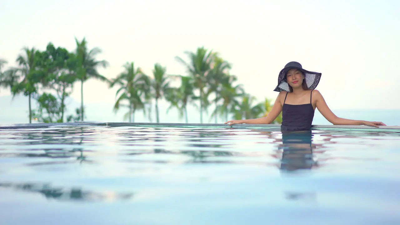 Fit Asian woman standing in Swimming Pool