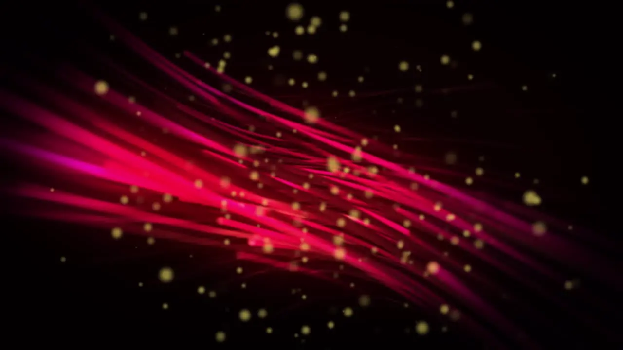 Animation of yellow spots over glowing red light trails against black background with copy space