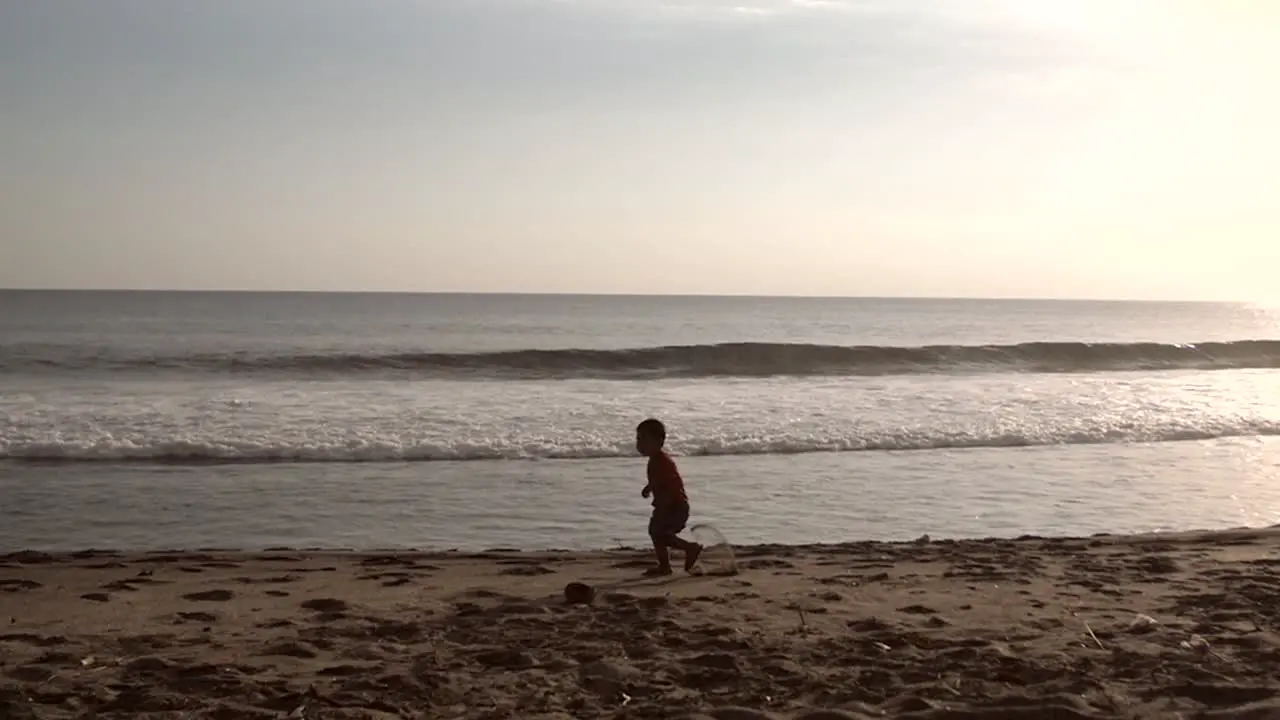 Small Boy Running in Slow Motion on a Beach